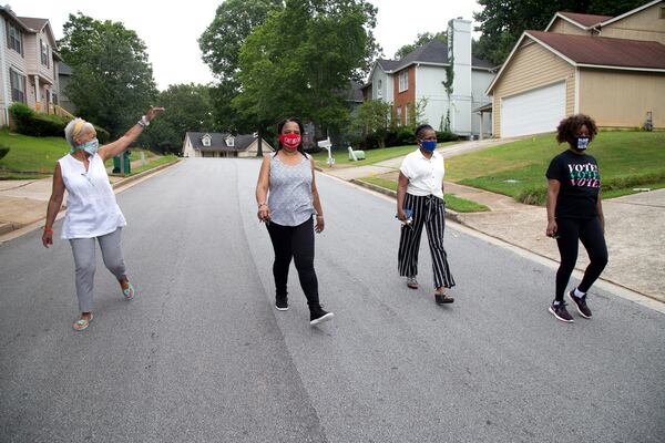 Jake Bryant, Renee Cail, Jennifer Wilson and Pyper Bunch walk around their neighborhood. STEVE SCHAEFER FOR THE ATLANTA JOURNAL-CONSTITUTION