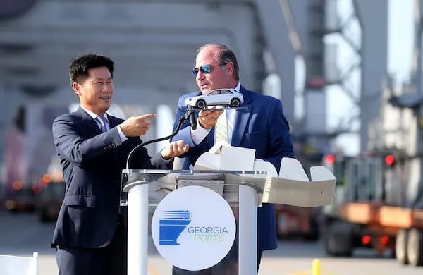 Oscar Kwon, HMGMA president and CEO, presents Kent Fountain, chairman of the Georgia Ports Authority Executive Board, with a model of an electric car during a special ceremony to mark the arrival of the first shipment of equipment for the Hyundai Metaplant on Monday, August 14, 2023 at the Georgia Ports. (Photo Courtesy of Richard Burkhart/Savannah Morning News)