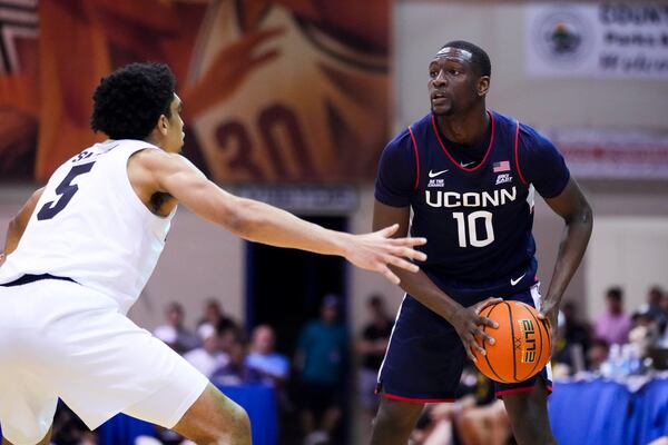 UConn guard Hassan Diarra (10) looks around the defense of Colorado guard RJ Smith (5) during the second half of an NCAA college basketball game at the Maui Invitational Tuesday, Nov. 26, 2024, in Lahaina, Hawaii. Colorado won 73-72. (AP Photo/Lindsey Wasson)