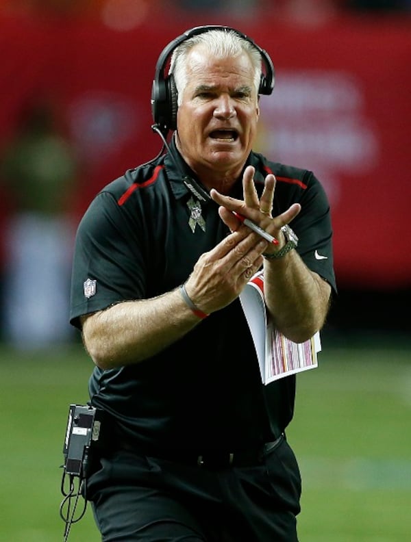 Atlanta Falcons head coach Mike Smith tries to call a time out during the first half of an NFL football game against the Cleveland Browns, Sunday, Nov. 23, 2014, in Atlanta. (AP Photo/John Bazemore) "Don't get a TO, baby!" (John Bazemore/AP photo)