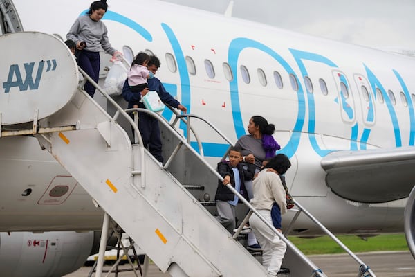 Honduran migrants who were deported from the U.S. deplane at Ramon Villeda Morales Airport in San Pedro Sula, Honduras, Wednesday, Dec. 4, 2024. (AP Photo/Moises Castillo)