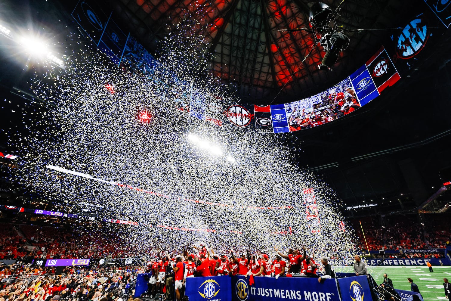 Georgia players celebrate on the awards stand after UGA defeated LSU 50 - 30 in the SEC Championship between the Georgia Bulldogs and the LSU Tigers In Atlanta on Saturday, Dec. 3, 2022. (Bob Andres / Bob Andres for the Atlanta Constitution)