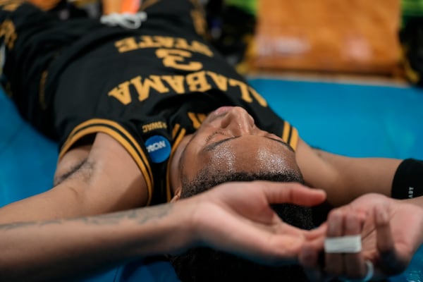 Alabama State guard CJ Hines (3) lies on the court against Auburn during the second half in the first round of the NCAA college basketball tournament, Thursday, March 20, 2025, in Lexington, Ky. (AP Photo/Brynn Anderson)