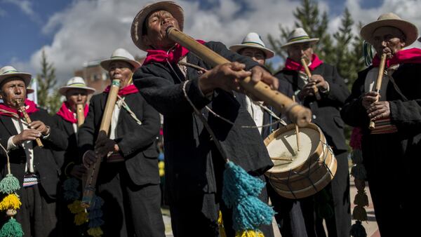 In this Jan. 29, 2017 photo, musicians perform for dancers on the shores of Lake Titicaca, as they practice before their presentation for the Virgin of Candelaria celebrations in Puno, Peru. Dancers in colorful masks and elaborate costume celebrate the Virgin of Candelaria, patron saint of communities along the shore of Lake Titicaca, in what's considered the largest Catholic festival in the Andes. (AP Photo/Rodrigo Abd)