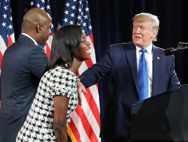 Janelle King, and her husband, Kelvin King, greet President Donald Trump at the 2019 launch of the Black Voices for Trump Coalition. King said it is tough being a black Conservative woman. “I would say that 98 percent of the attacks that come on me, come from black women, who seemingly understand what I am going through, but talk about me to make me feel less than confident,” King said. Curtis Compton/ccompton@ajc.com