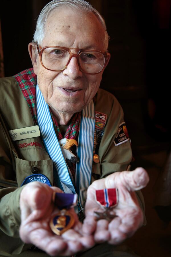 Josiah Benator holds his Purple Heart and Bronze Star Medal he received while serving in the WWII at his Atlanta home Friday, April 7, 2017. Benator has also overseen 53 Boy Scouts as they received their Eagle Scout rank during his 60 plus years as a scoutmaster. STEVE SCHAEFER / SPECIAL TO THE AJC