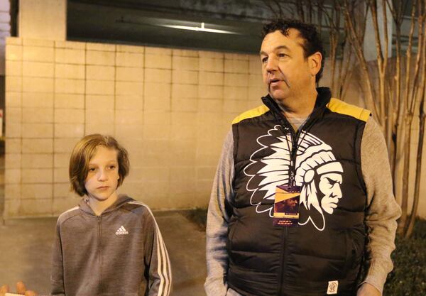 Hudson Holly (left) and dad Shawn Holly talk late on Thursday night after leaving a Ludacris show at the State Farm Arena. The duo were in town from South Carolina to enjoy the Super Bowl festivities though they will not be attending the game. EMILY HANEY / EMILY.HANEY@AJC.COM