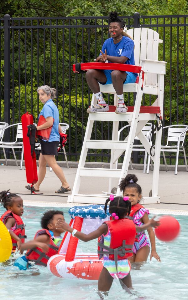 Lifeguard Tyler Norris watches swimmers atop his stand at the East Lake Family YMCA pool in Atlanta on June 28, 2024. PHIL SKINNER FOR THE ATLANTA JOURNAL-CONSTITUTION