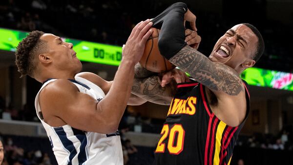 Memphis Grizzlies guard Desmond Bane (22) tangles up Hawks forward John Collins (20) resulting in a jump ball in the first half of a preseason game Saturday, Oct. 9, 2021, in Memphis, Tenn. (Nikki Boertman/AP)