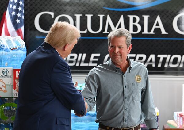 Former President Donald Trump (left) greets Gov. Brian Kemp while traveling to east Georgia to survey damage from Hurricane Helene on Friday, Oct. 4, 2024, in Evans. Over the last year, Kemp and other Republicans skeptical of Trump have made their peace with him. (Hyosub Shin/AJC)