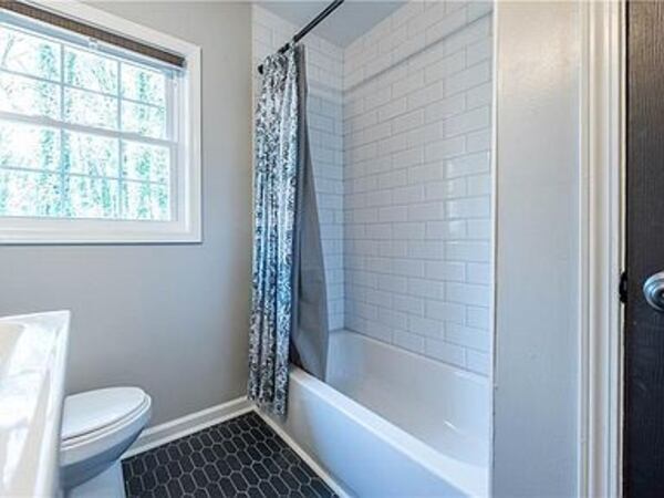 Custom tile work and designer vanities are in the bathroom.