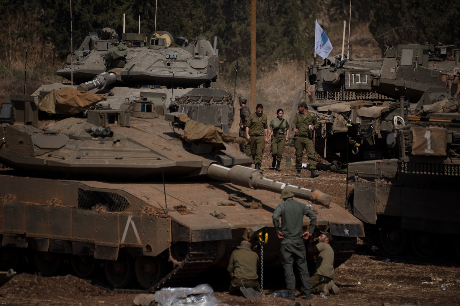 FILE - Israeli soldiers work on tanks and armoured personnel carriers (APC) in northern Israel, on Sept. 30, 2024. (AP Photo/Leo Correa, File)