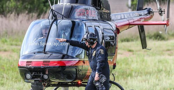 A helicopter joins the search for an escaped inmate at the River Station shopping center on West Fayetteville Road. 