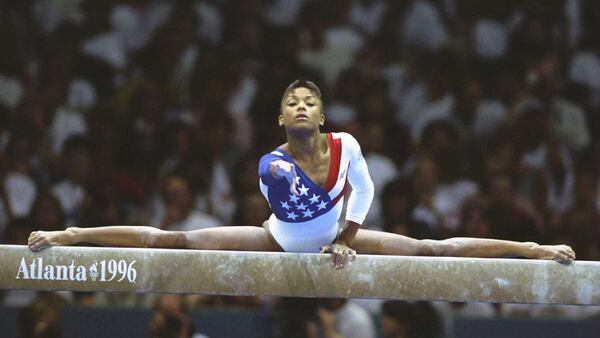 American gymnast Dominique Dawes performs on the balance beam during the women's team gymnastics event Tuesday, July 23, 1996, during the Summer Games at the Georgia Dome in Atlanta. (Doug Pensinger/Allsport)