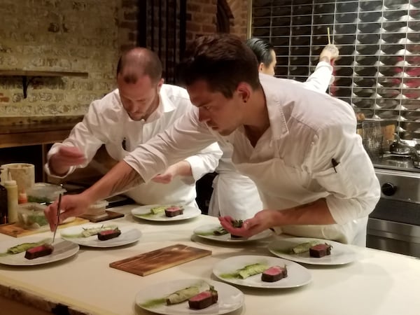 Kitchen staff at McCrady’s in Charleston, S.C., plate a course for the new tasting menu. CONTRIBUTED BY WESLEY K.H. TEO