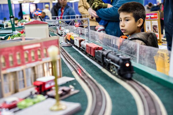 January 16, 2016 Norcross - Wyatt Boudway (right) watches a train pass by during the 50th annual Atlanta Model Train And Railroadiana Show And Sale at the North Atlanta Trade Center in Norcross on Saturday, January 16, 2016. JONATHAN PHILLIPS / SPECIAL