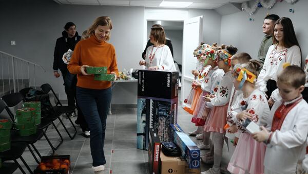 Olga Gorman, left, with presents for members of a Ukrainian children's choir.