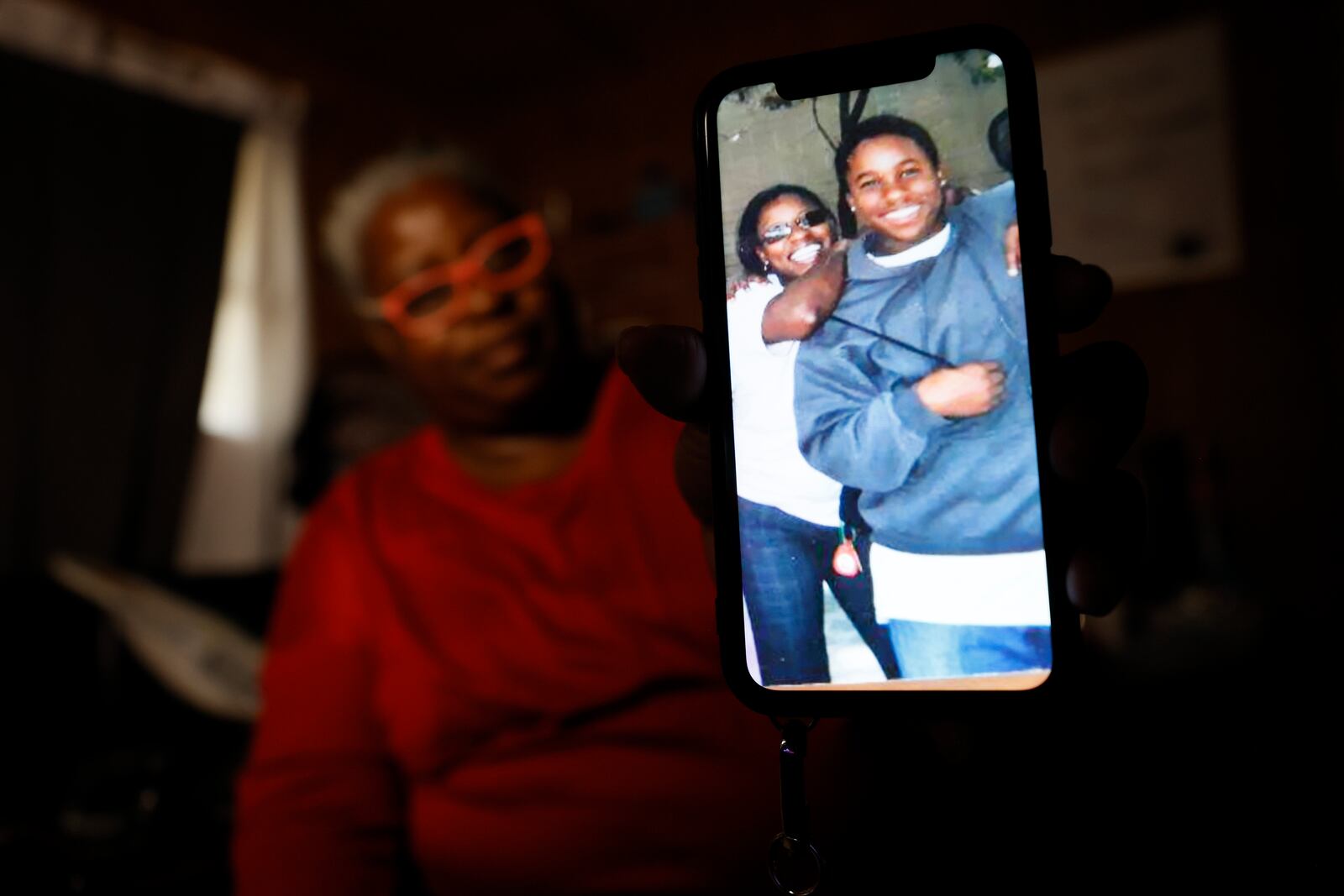 Sandra Reese shows a photo of her son Marcus Battle from 2006, the same year he returned from foster care to live with her. Reese says that Battle disengaged from school over the following years and, in 2011, dropped out altogether when he was a high school freshman. Miguel Martinez/miguel.martinezjimenez@ajc.com