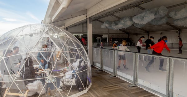 The Roof Top at Ponce City Market is continuing to operate through the pandemic, in part with help from the CARES Act programs, Wednesday, Dec 23, 2020.  The owner has been able to keep approximately 200 salary employees paid and working, while also filing unemployment for the hourly employees that had to be let go.  The ice skating rink, right, continues to operate through Jan 4, as in years past, and igloos are available for families to gather.  (Jenni Girtman for The Atlanta Journal-Constitution)