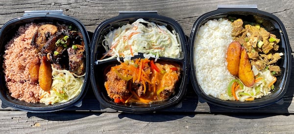 A takeout feast from Spicy Hill includes jerk chicken, fried chicken and curry goat. 
Wendell Brock for The Atlanta Journal-Constitution