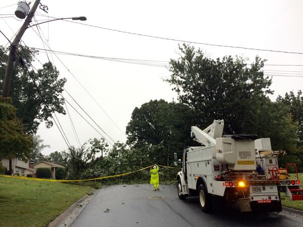 A utility worker arrives to inspect a downed tree and power lines on Vernon Oaks Drive in Dunwoody, Tuesday, September 12, 2017, following high winds and heavy rain from Tropical Storm Irma. J. SCOTT TRUBEY/STRUBEY@AJC.COM