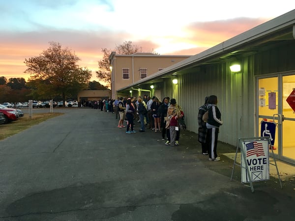 More than 100 people were lined up to vote at the Gwinnett County Fairgrounds in Lawrenceville before polls opened at 7 a.m. Tuesday. TYLER ESTEP / TYLER.ESTEP@COXINC.COM