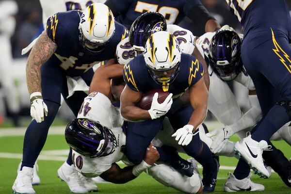 Los Angeles Chargers running back J.K. Dobbins (27) is tackled by Baltimore Ravens linebacker Malik Harrison (40) during the first half of an NFL football game Monday, Nov. 25, 2024, in Inglewood, Calif. (AP Photo/Eric Thayer)