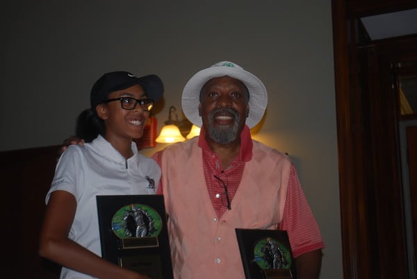 Ayanna Habrel from Edwards Middle School receives medalist trophy from Matt Adams