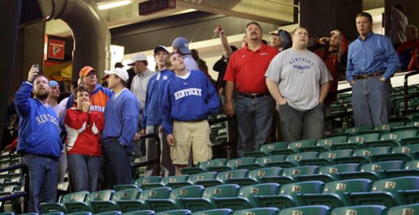 Friday: Basketball fans at the Georgia Dome looked up at damage to the roof in the minutes following the tornado downtown. Play at the men's SEC basketball tournament was stopped. Games were moved the following day to Georgia Tech.