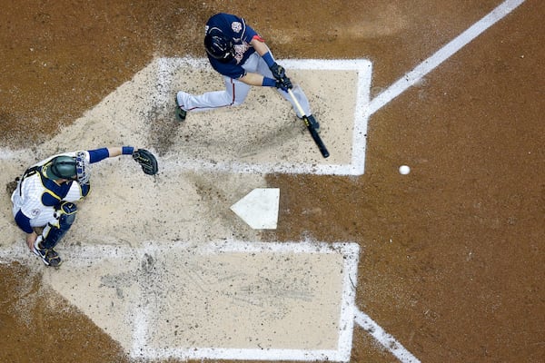 Atlanta Braves' Austin Riley hits a two-run scoring single during the third inning of a baseball game against the Milwaukee Brewers Friday, May 14, 2021, in Milwaukee. (AP Photo/Morry Gash)