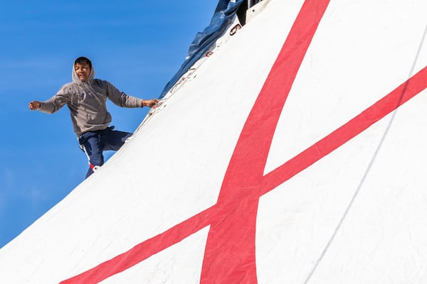 Diego Martinez begins closing the big-top tent as workers finish setting up for Germany’s Great Bavarian Circus at Stone Mountain Park. 