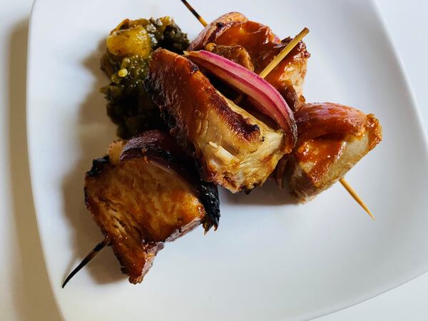 The pork belly skewers, served here with poblano and pina relish and furikake, are a popular menu item at Restaurant Holmes. CONTRIBUTED BY BOB TOWNSEND