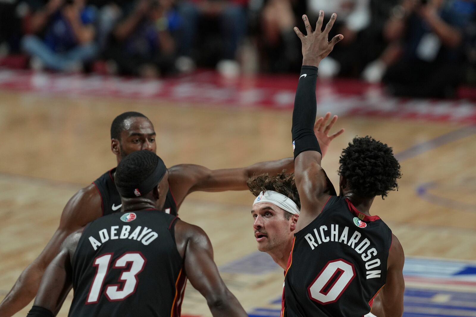 Washington Wizards Corey Kispert, center, goes to the basket as Miami Heat Bam Adebayo, left, and Josh Richardson defend during the first half of an NBA basketball game, at the Mexico Arena in Mexico City, Saturday, Nov. 2, 2024. (AP Photo/Fernando Llano)