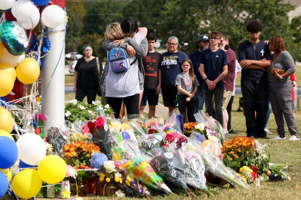 Mourners visit a makeshift memorial at Apalachee High School in Winder, where four people were fatally shot earlier this month. 