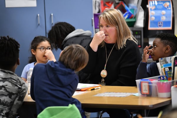 Teaching coach Katie Gaudette leads a small group during a literacy lesson in Jennifer Brems' first grade classroom at A.L. Burruss Elementary School, Friday, Feb. 3, 2023, in Marietta. (Hyosub Shin / Hyosub.Shin@ajc.com)