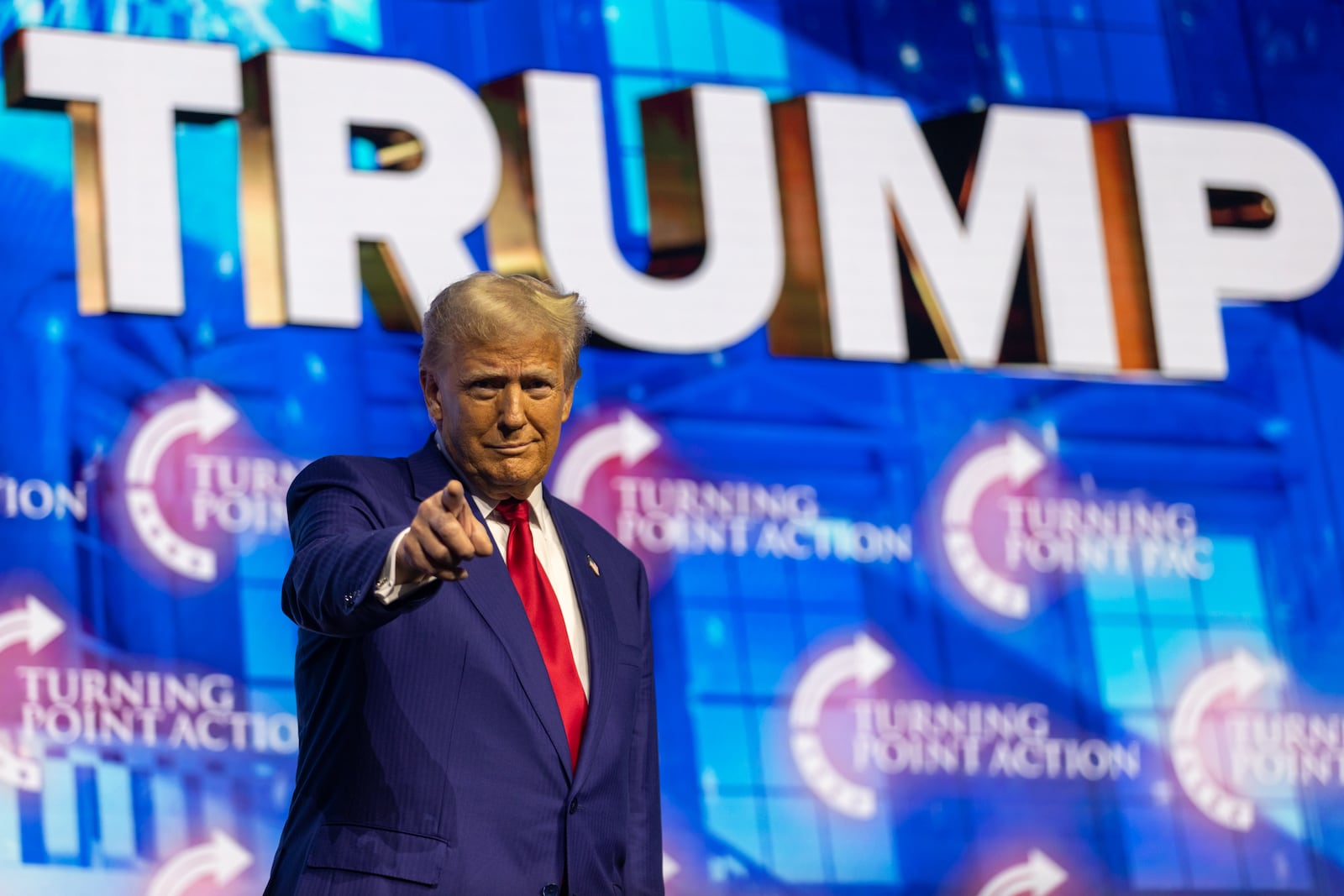 Republican presidential candidate Donald Trump takes the stage during his campaign rally at Gas South Arena in Duluth.