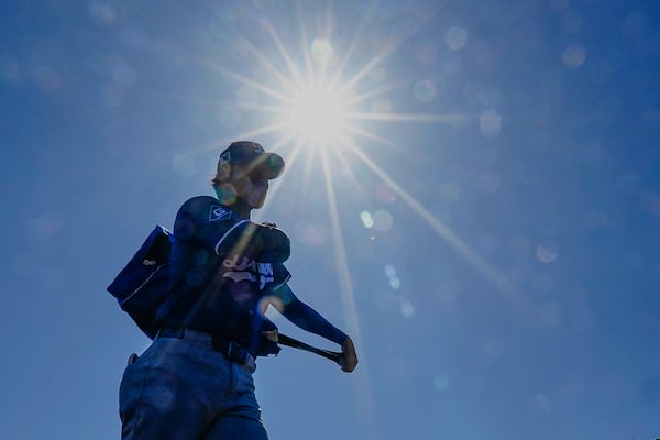 Los Angeles Dodgers two-way player Shohei Ohtani (17) makes his way into the dugout before their spring training baseball game against the Chicago White Sox, Saturday, March 8, 2025, in Phoenix. (AP Photo/Darryl Webb)