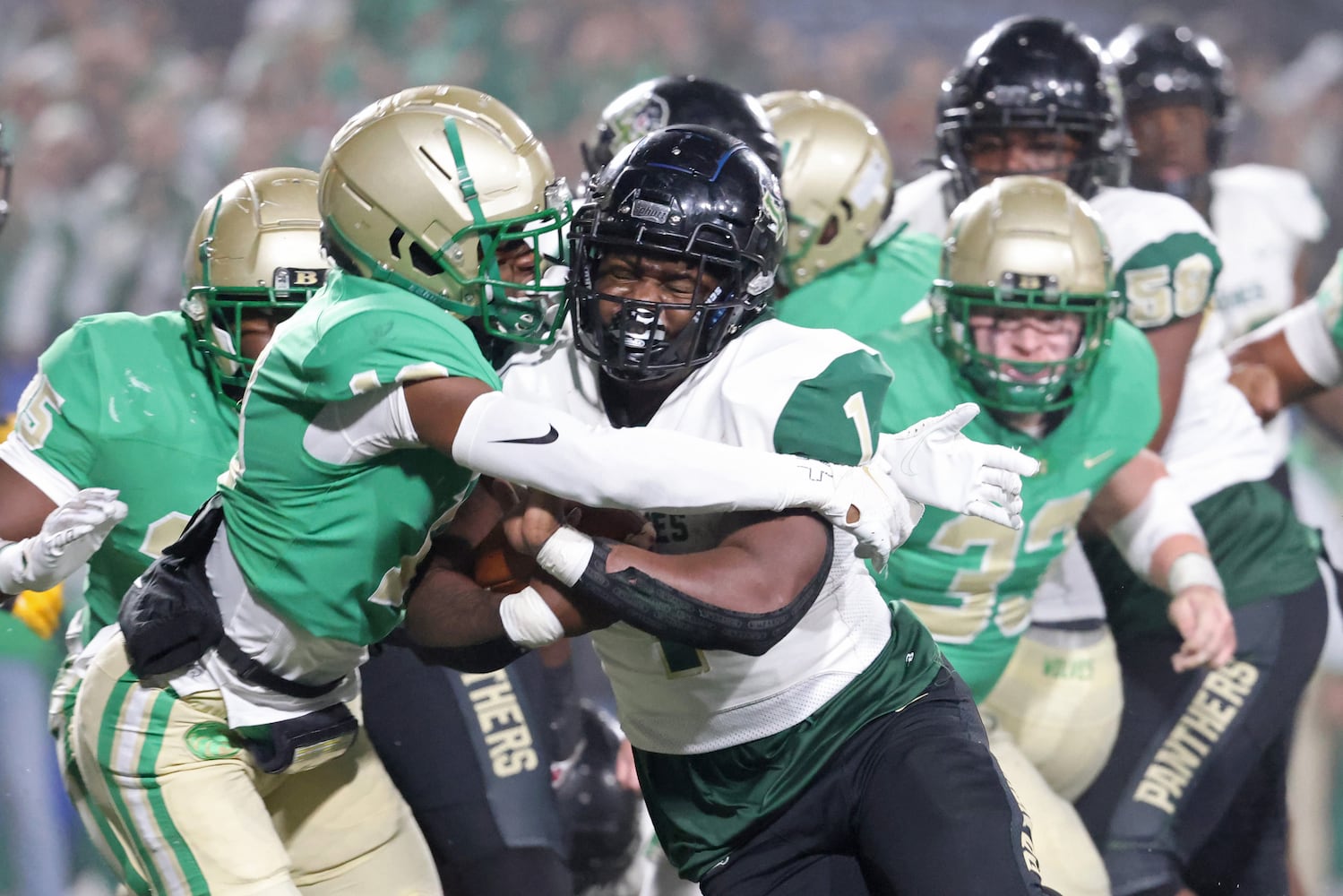 Langston Hughes running back Antonio Martin (1) runs against Buford defensive back KJ Bolden (19) to score a rushing touchdown in the first half during the Class 6A state title football game at Georgia State Center Parc Stadium Friday, December 10, 2021, Atlanta. JASON GETZ FOR THE ATLANTA JOURNAL-CONSTITUTION