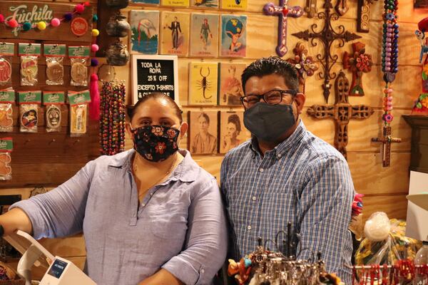 Veronica Triana and Victor Rivas, husband and wife and co-owners of Arte Terrestre. The artisan crafts and gifts store is located within Plaza Las Americas off Pleasant Hill Road in Lilburn (Tyler Wilkins / tyler.wilkins@ajc.com)