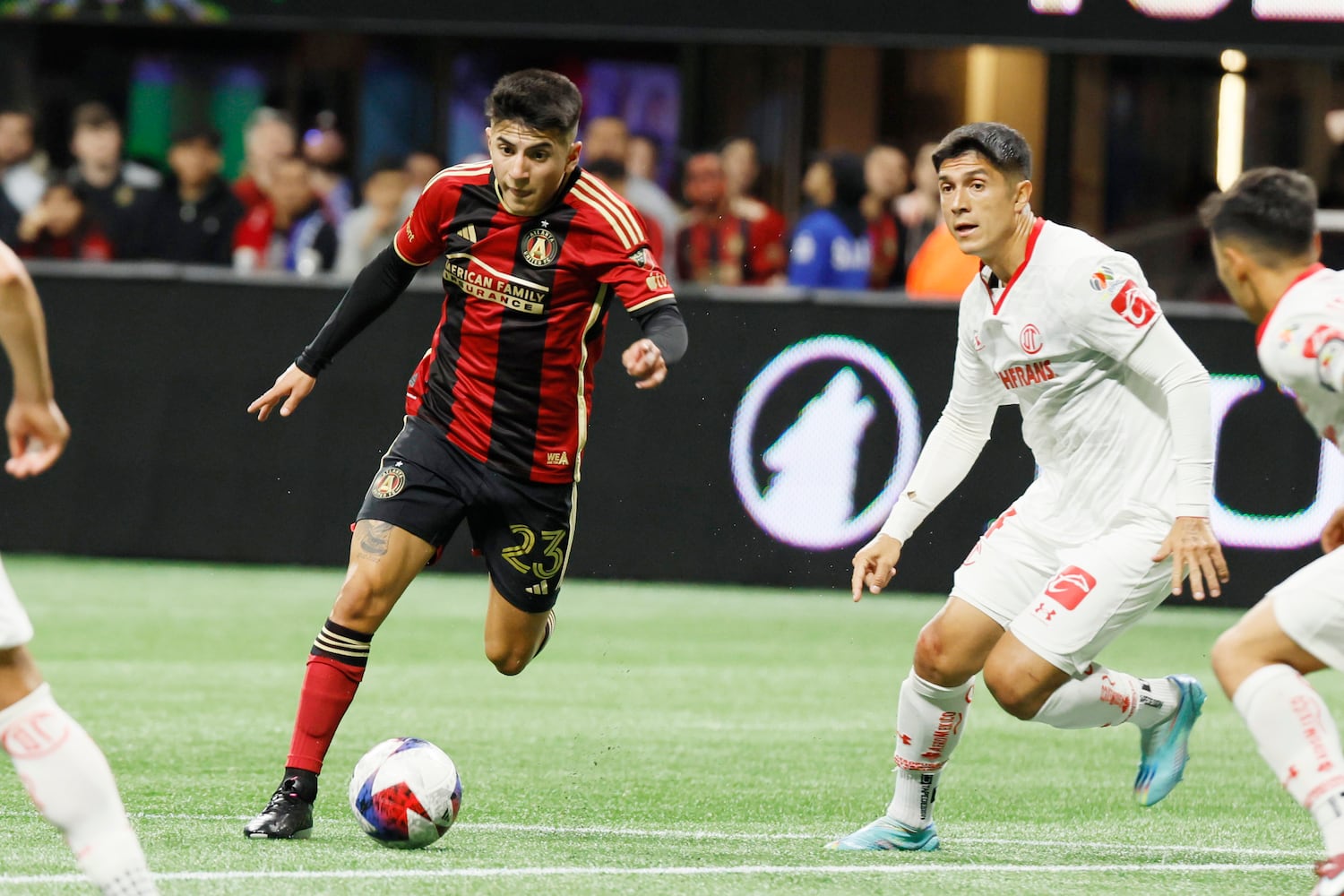 Atlanta United midfielder Thiago Almada (23) tries to get around Toluca defenders during the first half against Liga MX Toluca of an exhibition match on Wednesday, Feb 15, 2023, in Atlanta.
 Miguel Martinez / miguel.martinezjimenez@ajc.com