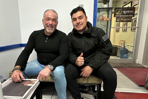 Eduardo Giraldo, left, and Sebastian Giraldo, voters in the part of the New York City borough of Queens that is represented by Rep. Alexandria Ocasio-Cortez, D-N.Y., pose for a photo on Nov. 12, 2024. The elder Giraldo, who owns an insurance business, voted for Vice President Kamala Harris, but his 24-year-old son, who is in the Air Force, voted for President-elect Donald Trump. (AP Photo/Philip Marcelo)