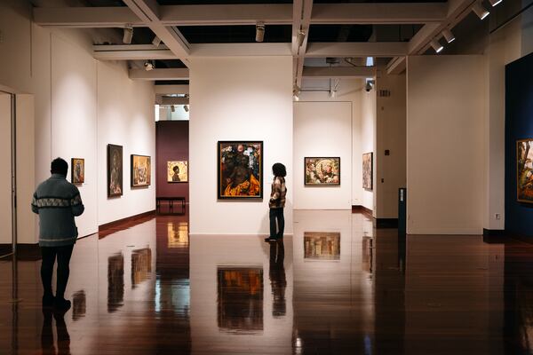 Visitors to the Spelman College Museum of Fine Art take in the Afro-Cuban Harmonia Rosales' Master Narrative exhibit last November. (Olivia Bowdoin for the Atlanta Journal-Constitution)