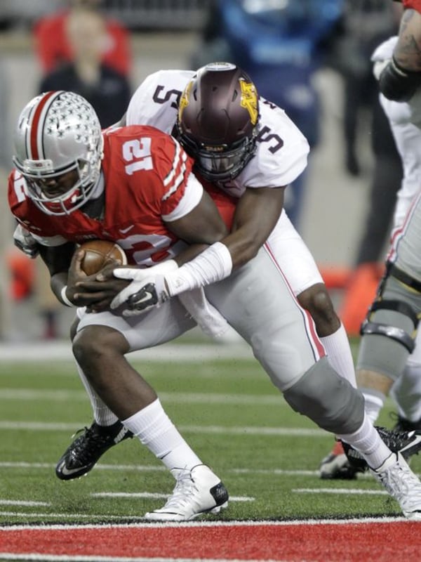  Minnesota defensive back Jalen Myrick tackling Ohio State quarterback Cardale Jones. (Associated Press)