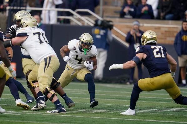 Georgia Tech's Dontae Smith (4) runs against Notre Dame's JD Bertrand (27) during the first half of an NCAA college football game, Saturday, Nov. 20, 2021, in South Bend, Ind. (AP Photo/Darron Cummings)