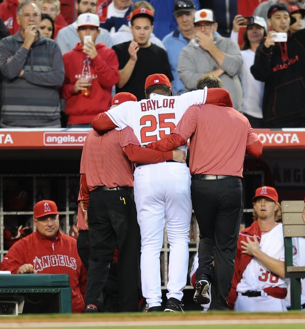 Los Angeles Angels batting coach Don Baylor injured his leg while catching the first pitch on Opening Day in Anaheim, Calif., Monday, March 31, 2014. (Wally Skalij/Los Angeles Times/MCT) Don Baylor is helped to the dugout. (Wally Skalij/L.A. Times - MCT)