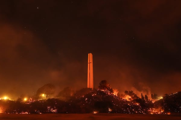 Vegetation around the Phillips Theme Tower at Pepperdine University is scorched by the Franklin Fire in Malibu, Calif., Tuesday, Dec. 10, 2024. (AP Photo/Jae C. Hong)