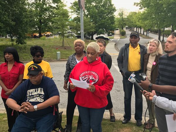 Melanie Douglas, a fired DeKalb bus driver, reads a statement urging Superintendent Steve Green to reconsider recent terminations related to a driver sickout. (Marlon A. Walker / marlon.walker@ajc.com)