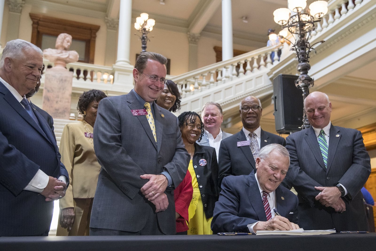 Georgia Governor Nathan Deal signs House Bill 930 at the Georgia State Capitol Thursday. The law allows 13 local counties to raise sales taxes for mass transit, if their voters consent. Gwinnett and Fulton counties already are planning votes. DeKalb and Cobb could be next. ALYSSA POINTER/ALYSSA.POINTER@AJC.COM