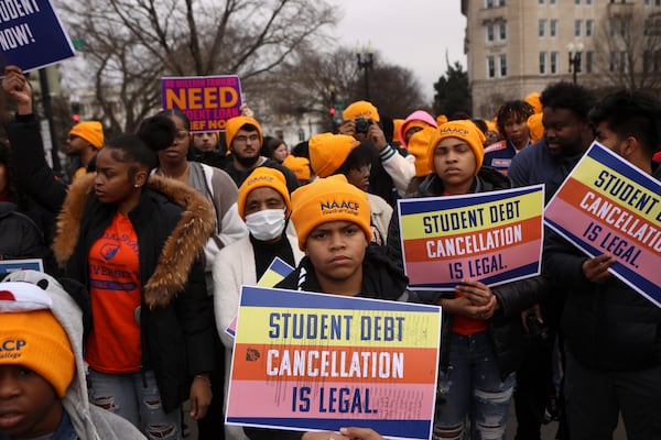 Demonstrators outside the Supreme Court, which is hearing two cases Tuesday about student debt, in Washington, Feb. 28, 2023. The court is expected to make a ruling early Friday on President Joe Biden’s student loan forgiveness plan. (Anna Rose Layden/The New York Times)