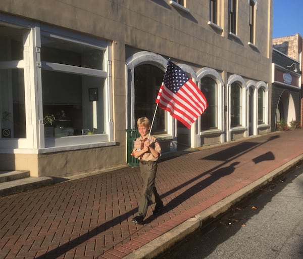 Cub Scout Martin Raybon was up early to set up flags in downtown Toccoa. Photo: Jennifer Brett